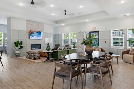 A modern dining room with a large table and chairs.