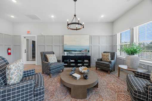 A living room with a fire extinguisher on the wall.