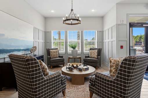 A living room with a large window and a view of the mountains.