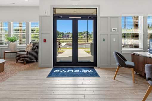 A modern interior with a view of the outdoors through a glass door.