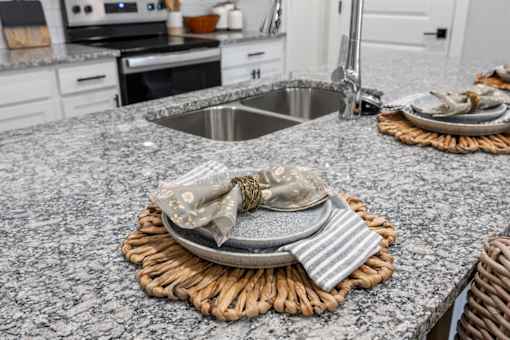 A kitchen counter with a plate and napkin on it.