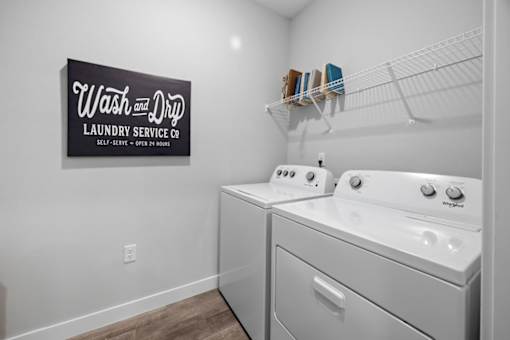 A laundry room with a Wash and Dry sign on the wall.