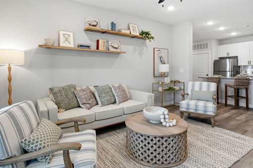 A living room with a grey couch and a wooden coffee table.
