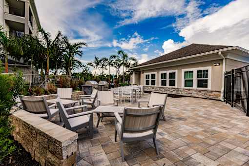 several chairs and tables in front of Vantage apartments clubhouse building