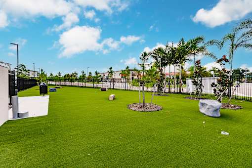 dog park with green turf and a fence at Vantage Luxury Apartments in  Cape Coral, FL