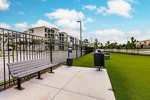 dog park with green turf and a fence at Vantage Luxury Apartments in  Cape Coral, FL