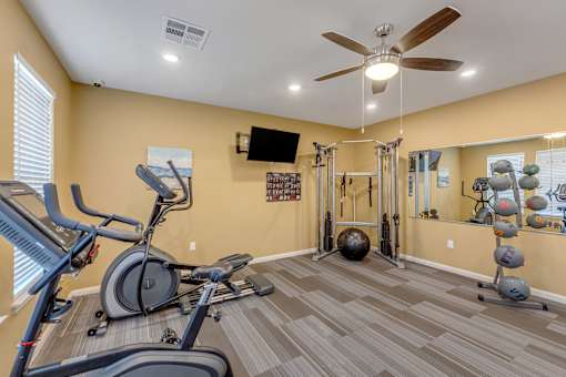 A spacious home gym with a variety of exercise equipment.