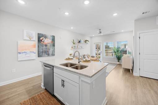 A kitchen with a white countertop and a sink.