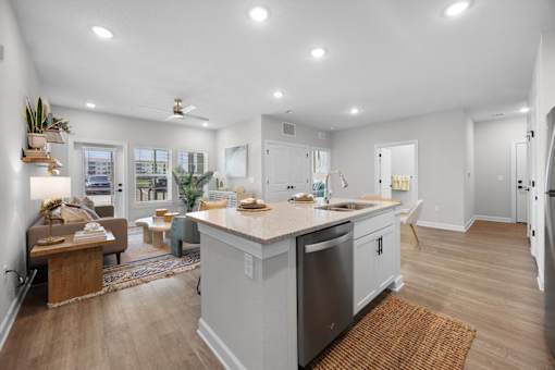A modern kitchen with a large island and stainless steel appliances.