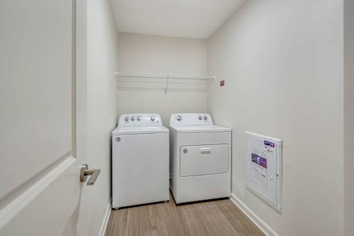 A small laundry room with a washer and dryer.