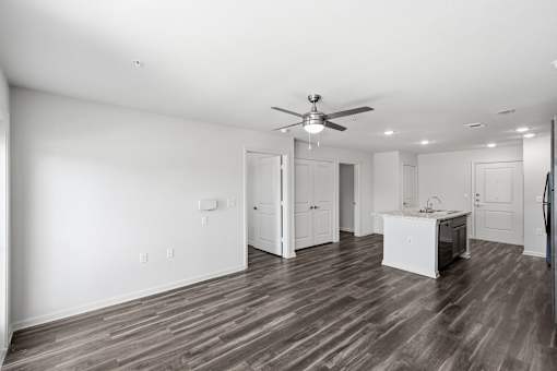 A photo of a living room with a ceiling fan.