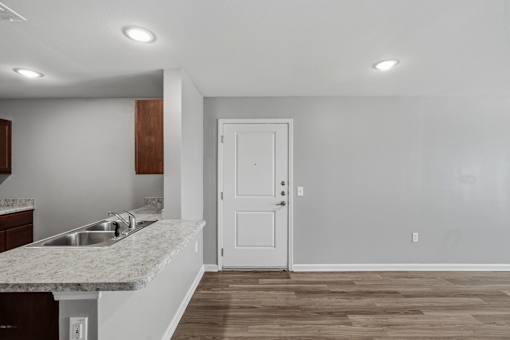 A kitchen with a sink and a door.