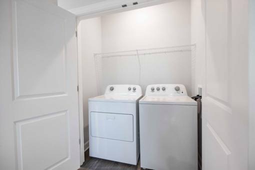 A white bathroom with two sinks and a door.