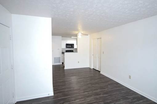 A room with white walls and a wooden floor.