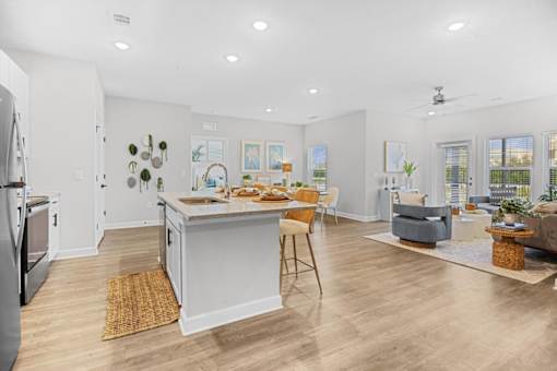 A kitchen with a dining table and chairs in the middle of the room.