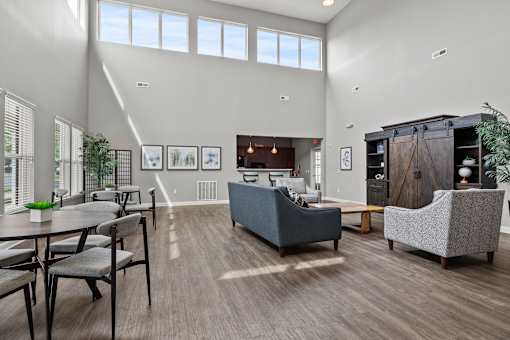 A modern living room with a grey sofa and a wooden cabinet.