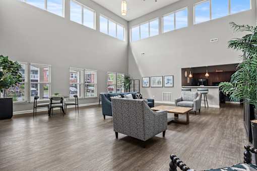 A spacious waiting room with a variety of seating options and pictures on the wall.
