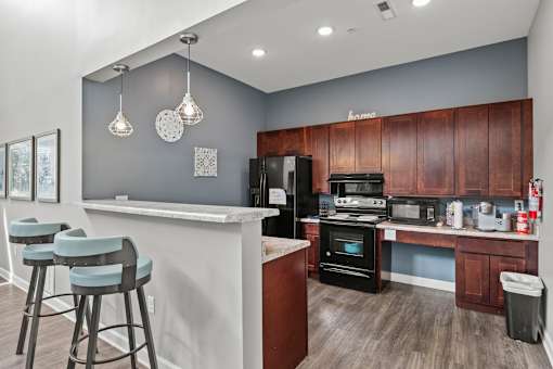 A kitchen with a bar area and a refrigerator.