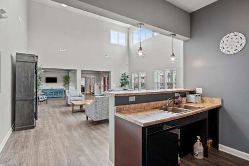 A kitchen with a sink and a countertop with a bag of chips on it.