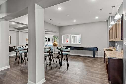 A modern dining room with a long table and chairs.