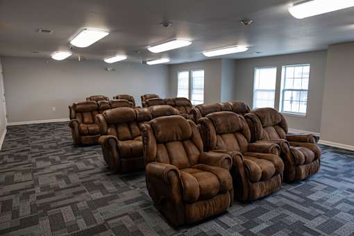 A room full of brown recliner chairs.