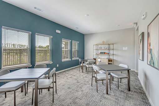 A conference room with a long table and chairs.