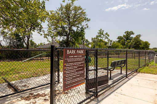 A sign in front of a fence that says Dark Park.