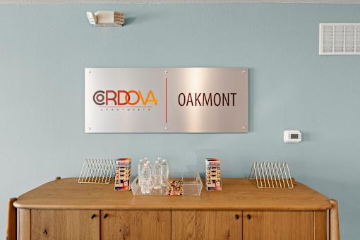 A wooden table with a metal sign that says Oakmont above it.