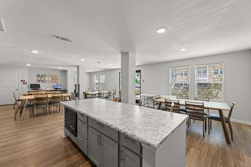 A kitchen with a large island and dining area.