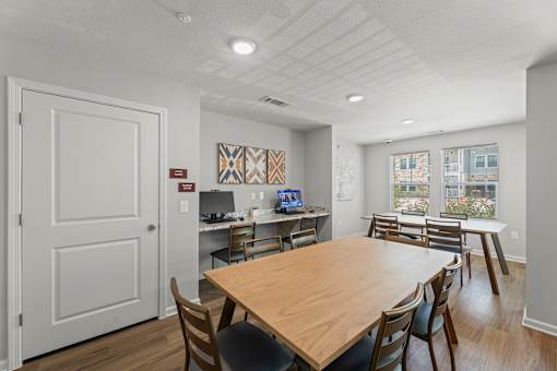A dining room with a wooden table and chairs.