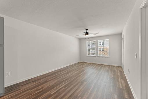 A room with wooden flooring and a ceiling fan.