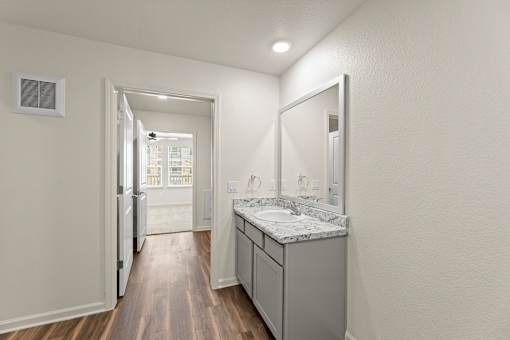 A bathroom with a sink and mirror.