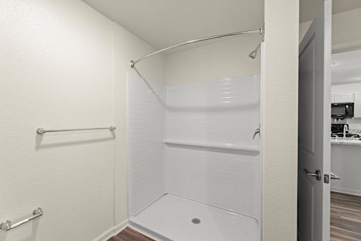 A white bathroom with a walk-in shower.