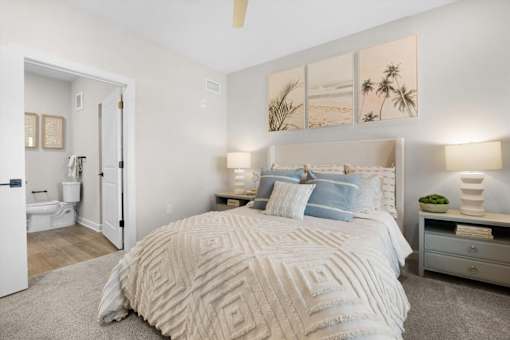 A bedroom with a large bed and a ceiling fan.