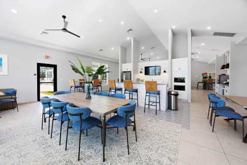 A spacious room with a long table surrounded by chairs.