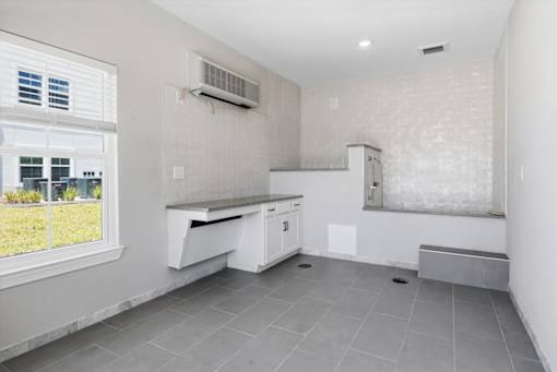 A kitchen with a window and a bench.
