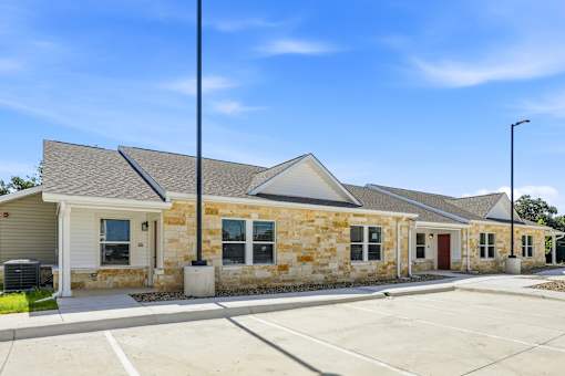 A building with a parking lot in front of it.