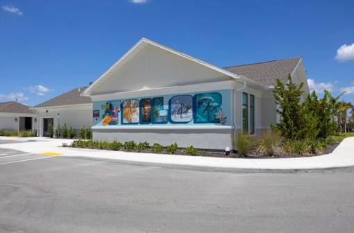 A building with a mural of cartoon characters on the side.