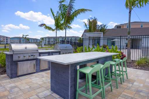 An outdoor kitchen with a table and chairs.
