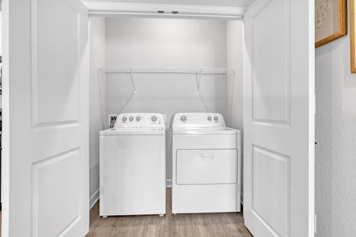 A white laundry room with a washer and dryer.