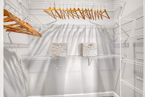 A white refrigerator with a few items on the shelves.
