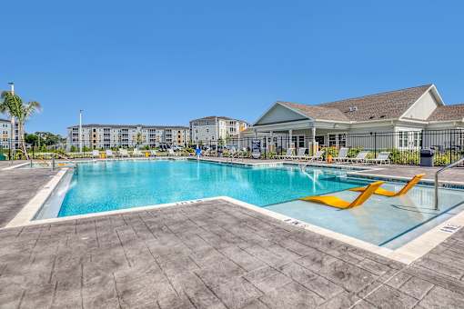 A large swimming pool with a slide in the middle of it.