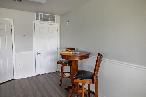 A small table with a chair in a room.
