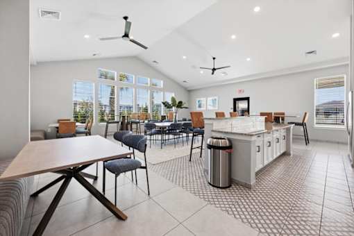 A modern kitchen and dining area with a large island and chairs.