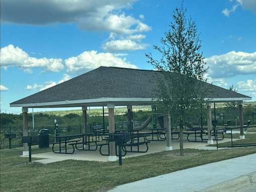 a pavilion with picnic tables