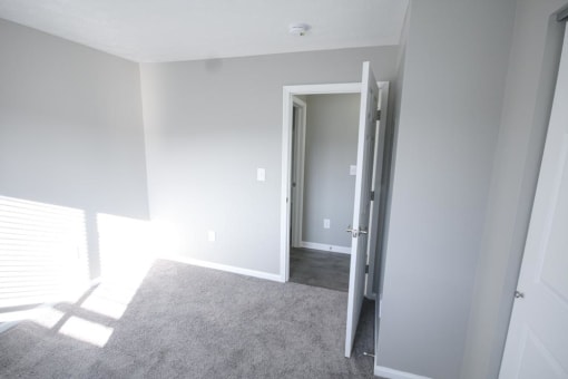 Empty bedroom with a door open at Canterbury House apartments in Logansport, Indiana