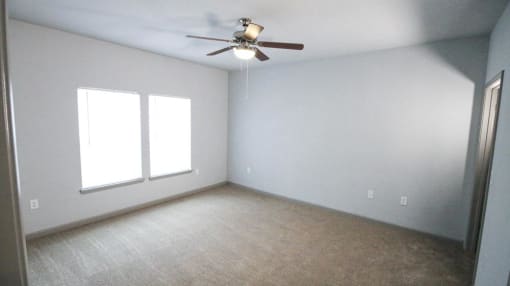 Bedroom with a ceiling fan and two windows at Mosaic Apartments in Avon, Indiana