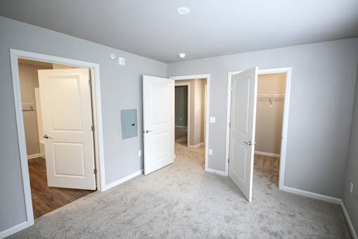 A room with four doors, one of which is open.
