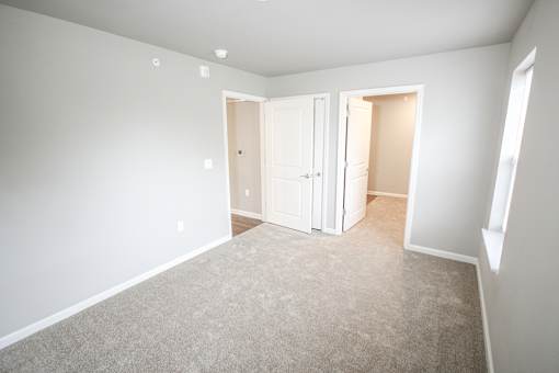 A room with white walls and a carpeted floor.
