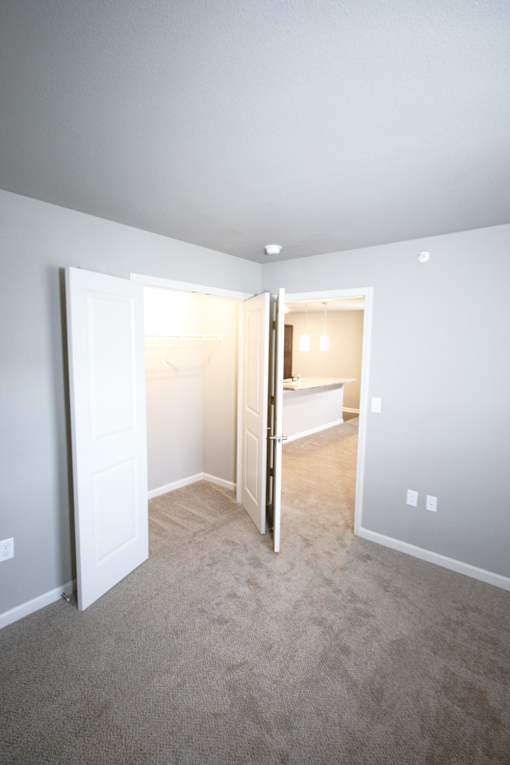 A room with a carpeted floor and white walls.